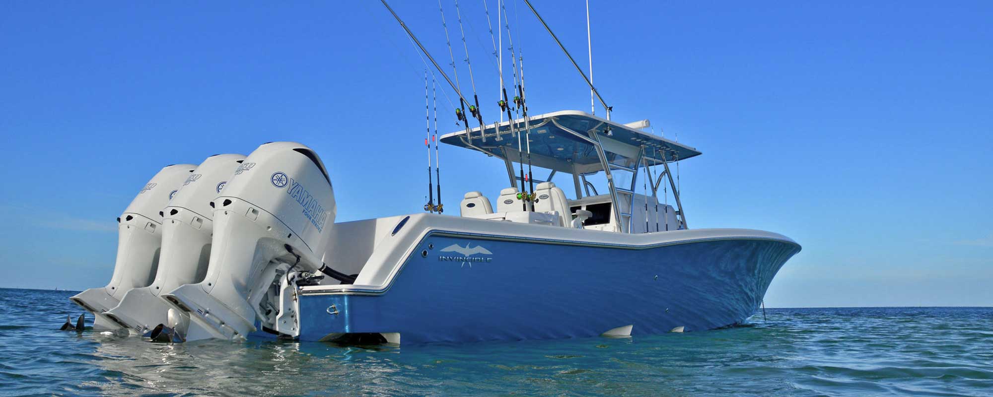 Invincible boat anchored offshore with yamaha outboards